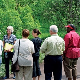 A group of people on a garden tour in spring. 