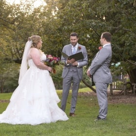 A bride, groom, and officiant. 
