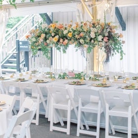 A wedding dinner table set with flowers and candles.