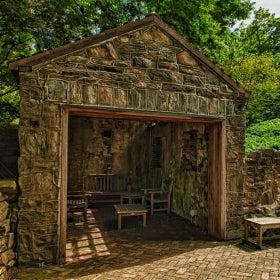 A historic springhouse made of stone.