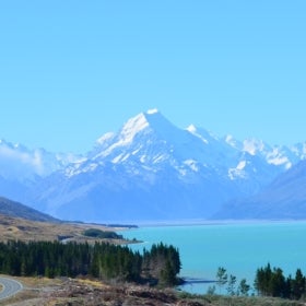 A large mountain behind crystal clear water.