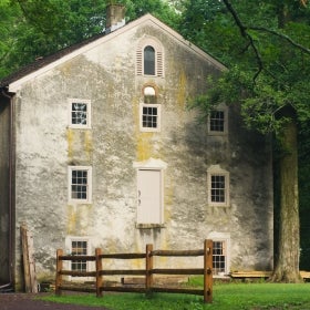 A historic grist mill set in a wooded area.