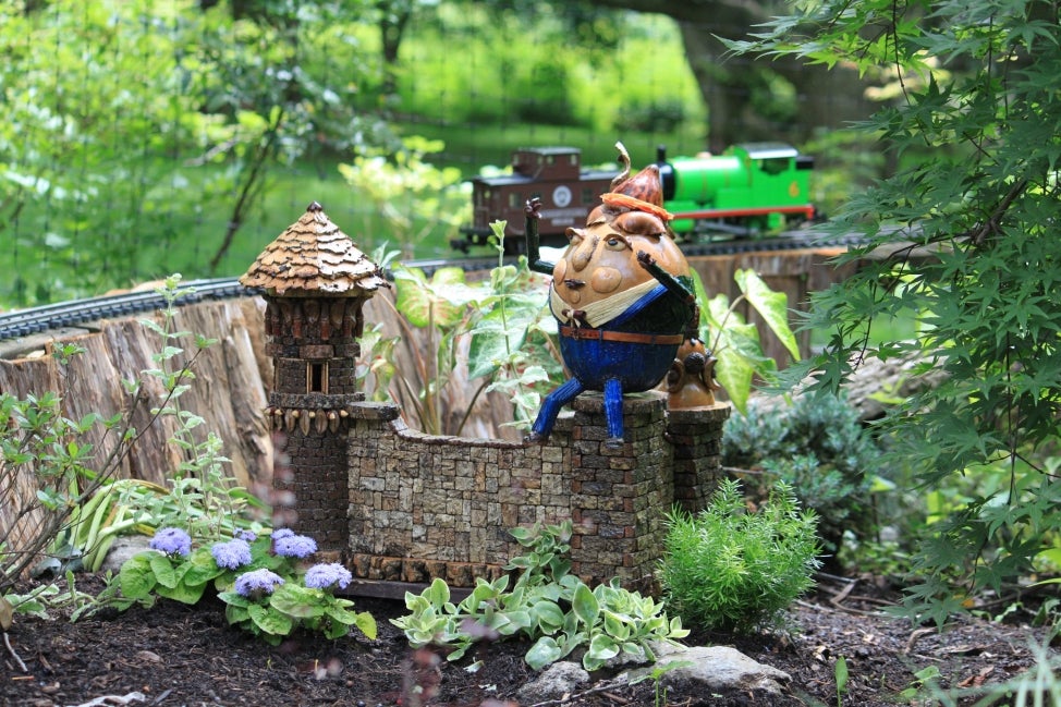 A miniature replica of Humpty Dumpty in a model train display. 