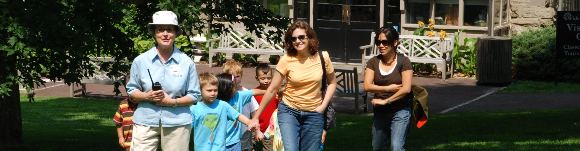 A group of people being led on a garden tour by a guide. 