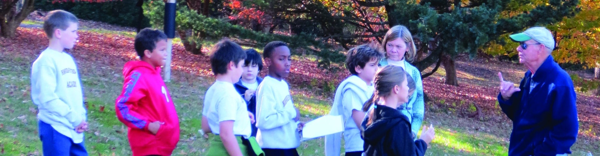 A group of children taking a public garden tour in fall. 