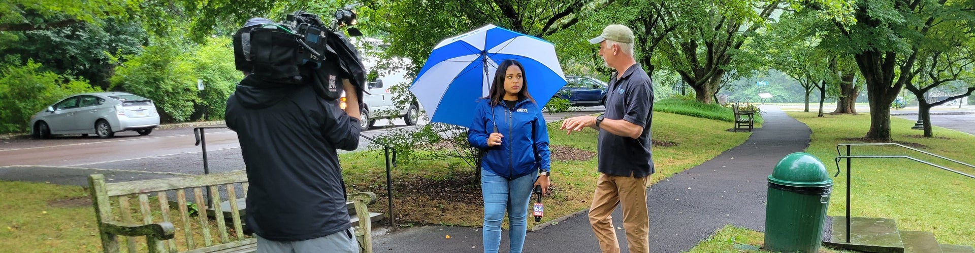 a man talking to a woman in front of a camera