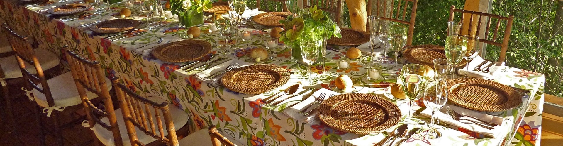 A decorated table with flowers and place settings.