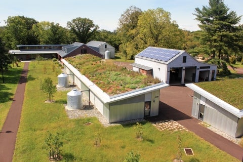An aerial view of a series of buildings, one with a rooftop garden.