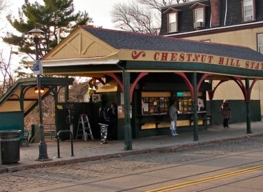 A train newsstand that reads, "Chestnut Hill Station."