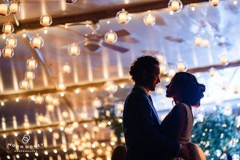 A bride and groom danced under a ceiling of floating candles. 