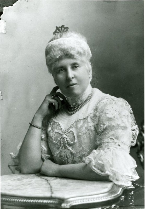 A black and white photo of a woman in the late-1800s. 