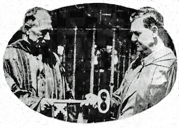 A black and white image of two men in 1933 holding a large key. 