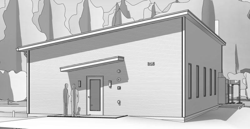 A black-and-white plan of a small building with a slant roof surrounded by trees.